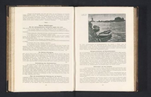 View of a waterway with rowboats moored in the foreground