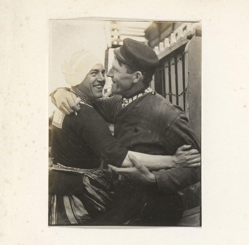 Two men in traditional dress, one of whom is in women's clothing