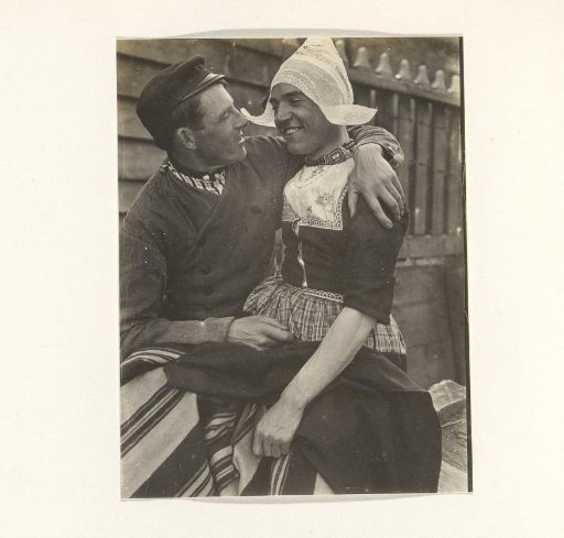 Two men in traditional dress, one of whom is in women's clothing