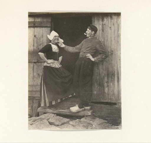 Two men in traditional dress, one of whom is in women's clothing