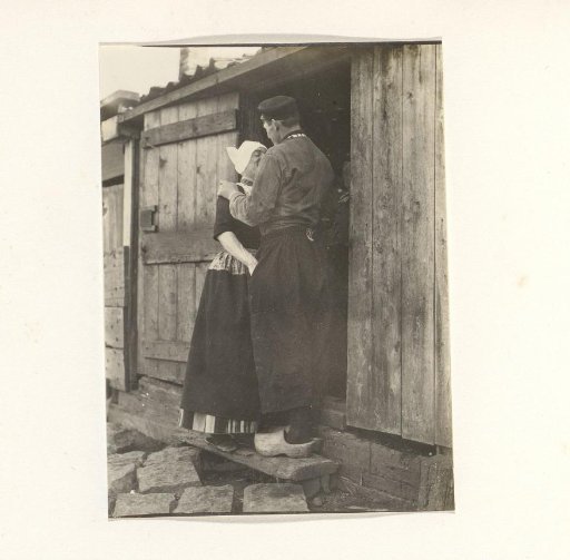 Two men in traditional dress, one of whom is in women's clothing