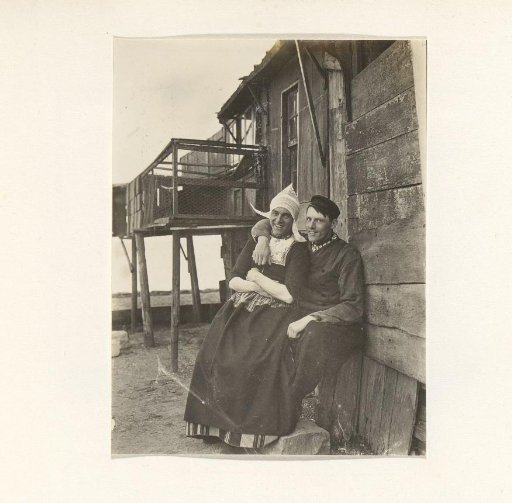 Two men in traditional dress, one of whom is in women's clothing