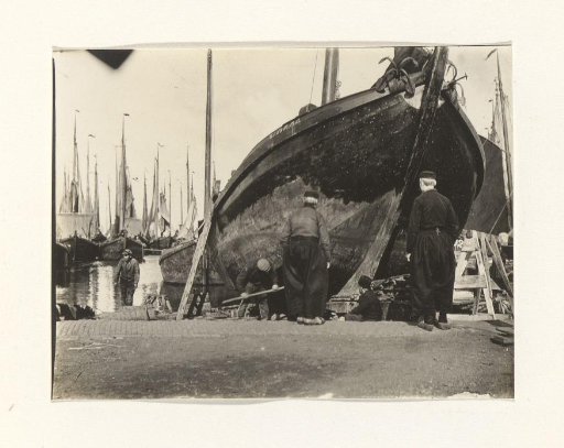 Harbor workers by a boat in the harbor at Volendam