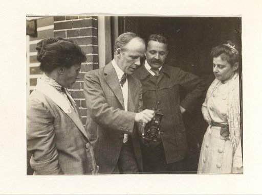 Men and women in a doorway with a camera