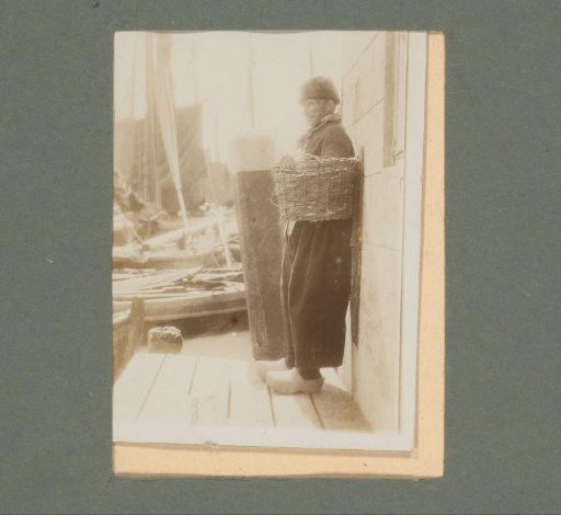 Man in traditional dress standing on a jetty