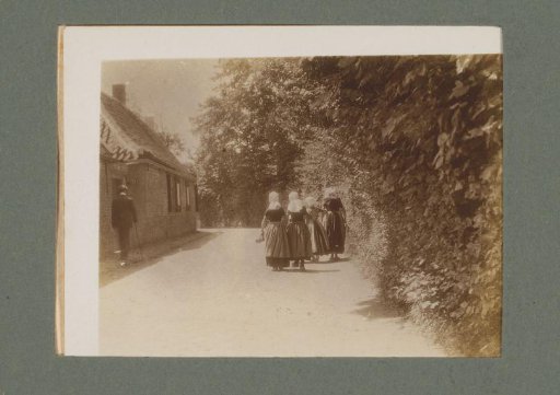 Four girls in costume, seen from behind