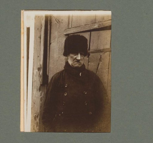 Portrait of a man in a dark coat and cap