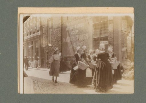 Women in costume with baskets in the street