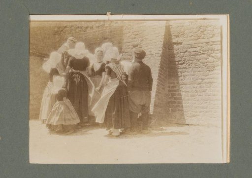 Group of people in costume standing in front of a building wall