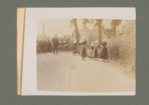 Women, Girls, and a Man in Traditional Dress, Seen from Behind