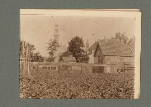 View of a Kitchen Garden with a Church Tower in the Background