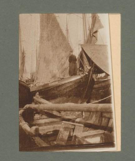 Man in traditional dress standing on a sailing boat in Volendam
