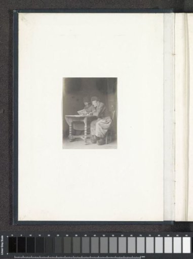 Portrait of two men in Volendam costume, seated at a table
