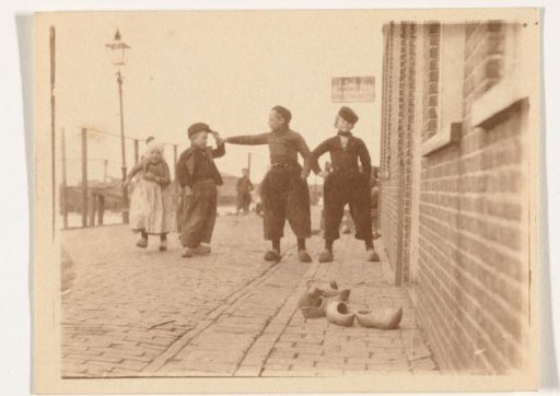 Children in traditional dress in Volendam, with several clogs in the foreground