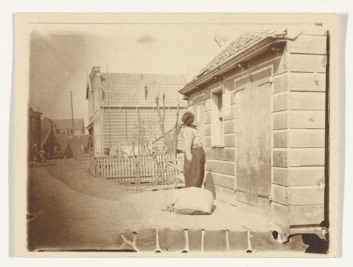 Unknown man in traditional dress in front of a house in Volendam