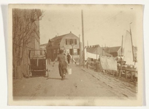 Two men in traditional dress along the harbor in Volendam