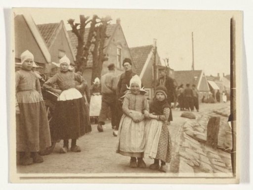 People in traditional dress in Volendam, with several children in the foreground