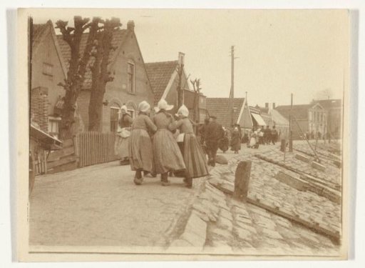 View of a dike in Volendam with people in traditional dress