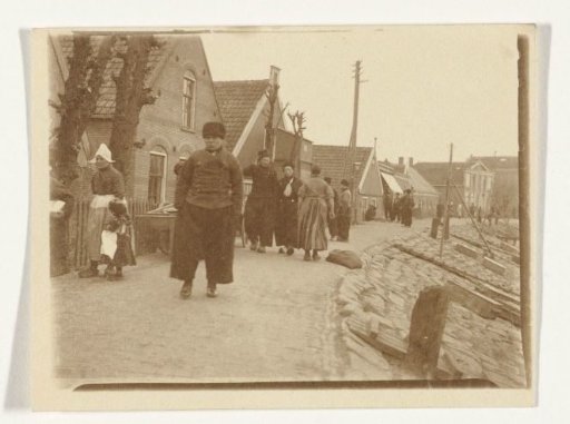 View of a dike in Volendam with people in traditional dress