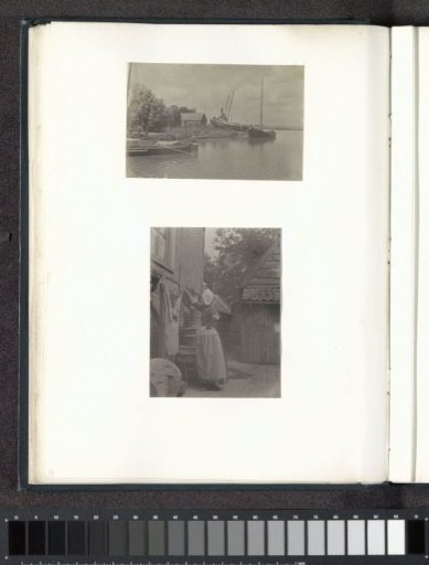 Woman in costume hanging laundry, probably in Volendam