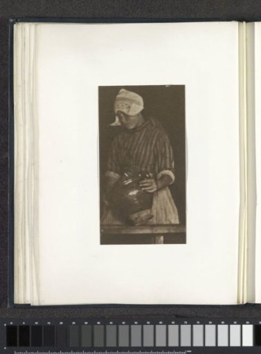 Portrait of a girl in costume holding a jug, probably in Volendam