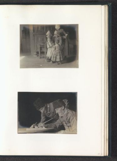 Portrait of two men in Volendam costume, seated at a table