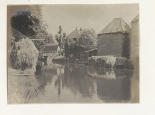 Man in costume standing on a dike at Volendam