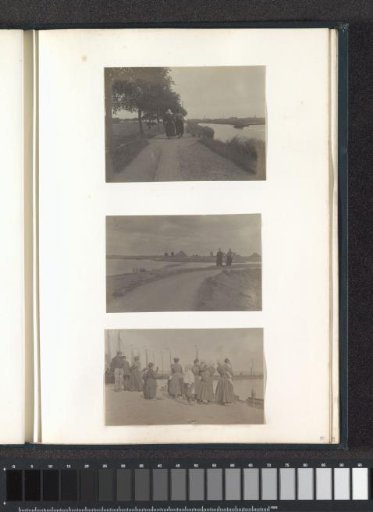 Two men in costumes on a dike near Volendam