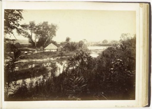View of a house along the river with a fermentation shed in the background, Langkat Sumatra