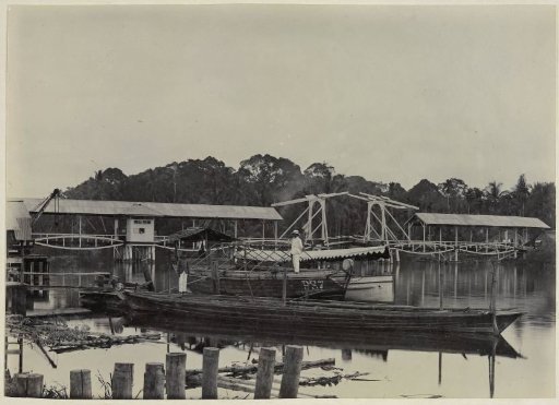 Paul Sandel on boat PS 7 in front of the Sandel bridge in the Wampoe river, Tandjong Poera, Langkat Sumatra