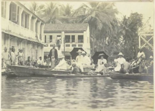 Group of Europeans, including Maggy Sandel, rowing through the flooded streets of Tandjong Poera, Langkat Sumatra