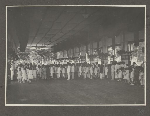 Rows of celebrating people in the reception hall of the palace of the Sultan of Langkat, Sumatra