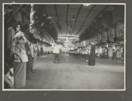 Rows of celebrating people in the reception hall of the palace of the Sultan of Langkat