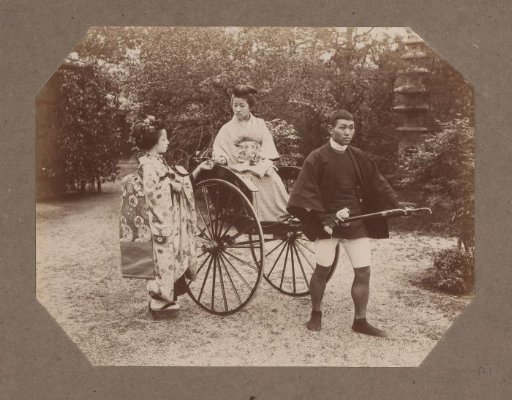 Woman in a rickshaw giving a flower to another woman, Japan