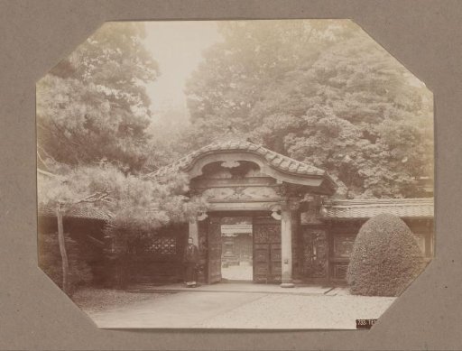 Man at the gate of a temple in Shiba, Tokyo, Japan