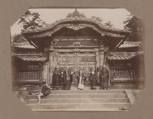 Men at the gate of a temple in Shiba, Tokyo, Japan