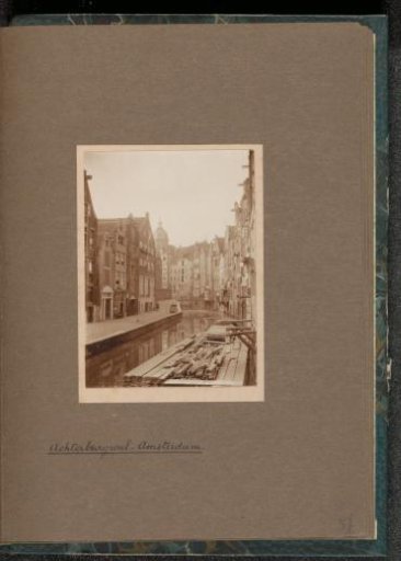 Houses on the Oudezijds Achterburgwal in Amsterdam with the Dome of the Saint Nicholas Church in the Background