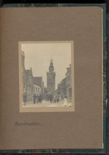 People walking in the Kerkstraat in Monnickendam with the Speeltoren in the background