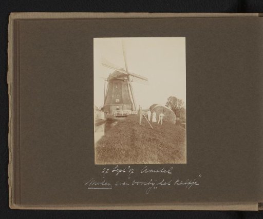 Two Men and a Woman Beside a Windmill