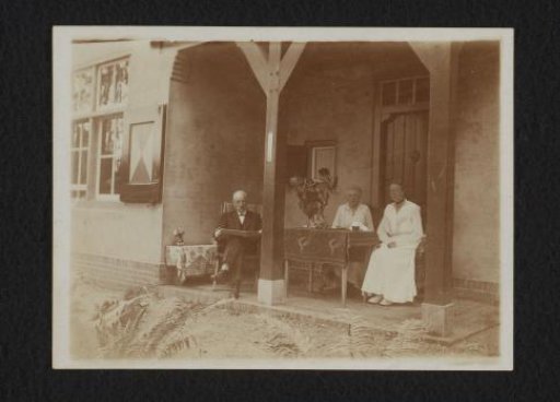 Man and two women on a veranda