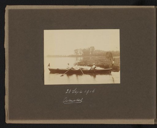 Three persons in a rowing boat on the Amstel