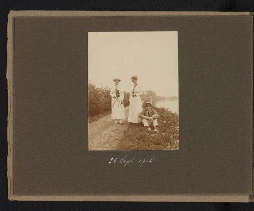 Two women and a man along the Amstel, a woman operating the camera