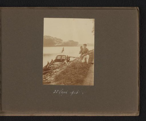 Man along the Amstel with a camera