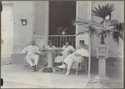 Group portrait on a veranda of two men in uniform and two women