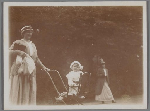 Mother with Child and Baby Carriage in a Park, Camera Case Under Her Arm