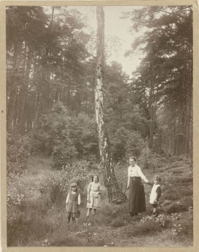Marba and Eckart Titzenthaler, children of the photographer, and an unknown girl and an unknown woman in a forest