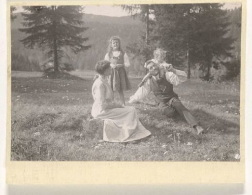 Waldemar Titzenthaler, the photographer, with his wife Olga and children Marba and Eckart sitting in a field