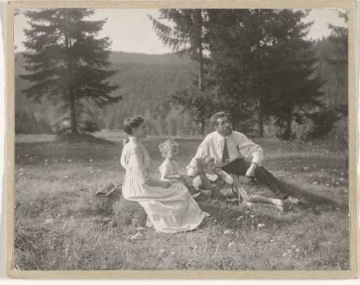 Waldemar Titzenthaler, the photographer, with his wife Olga and children Marba and Eckart sitting in a field