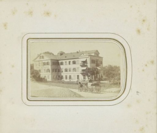 Exterior of the Hotel Nelboeck in Salzburg with a horse-drawn carriage in front