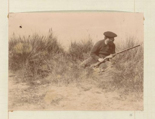 Hunter in the dunes, seated